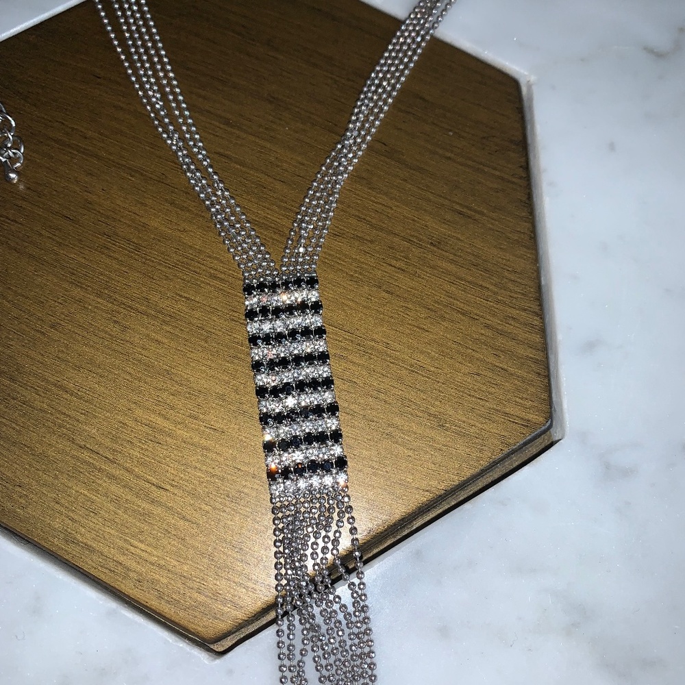 Lariat-type necklace in silver tone with crystals by Melanie Lyne.